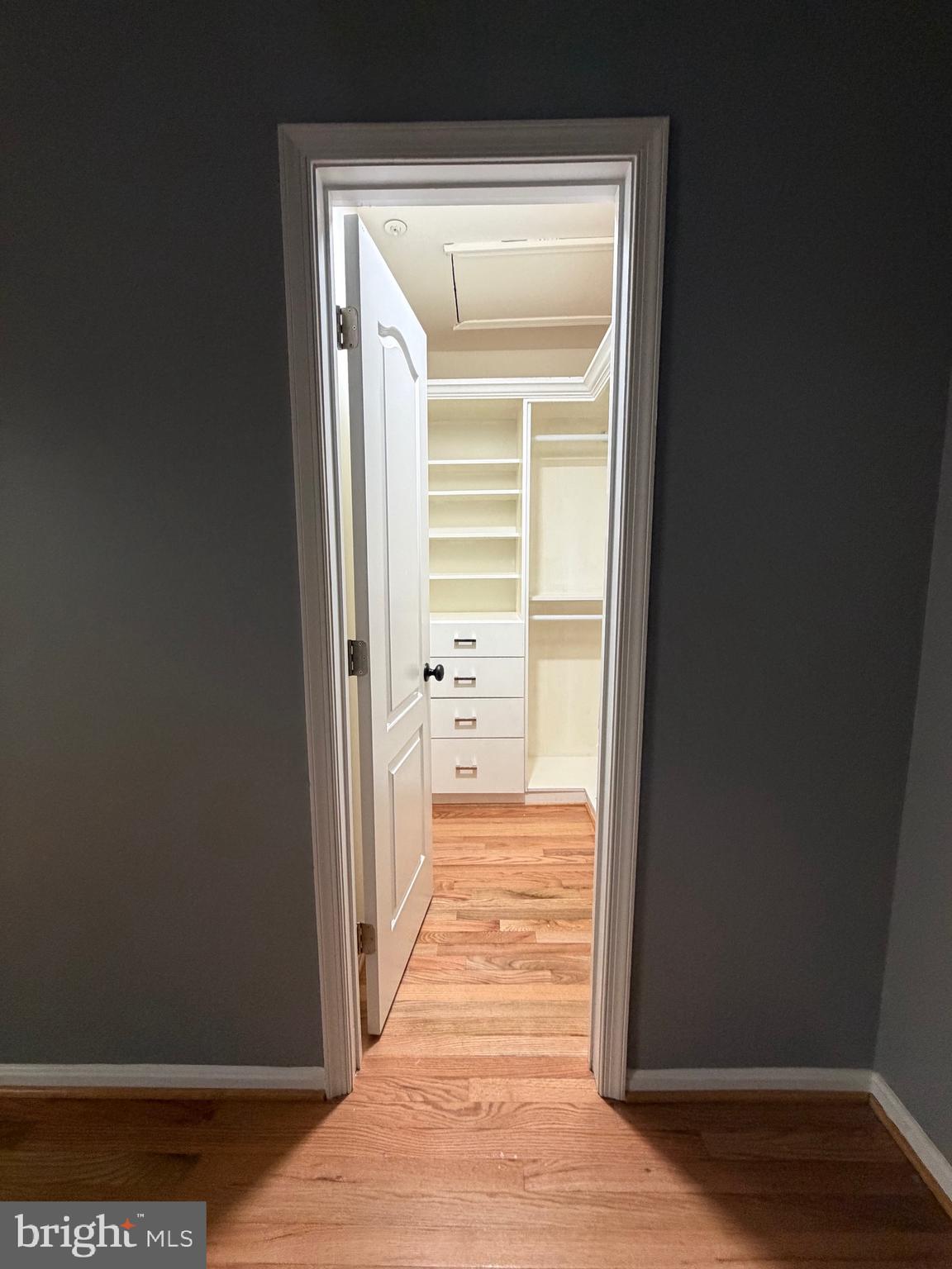 7704 Periwinkle Way Severn, MD 21144 - Photo 12 of 18 a view of a hallway with wooden floor and a bathroom
