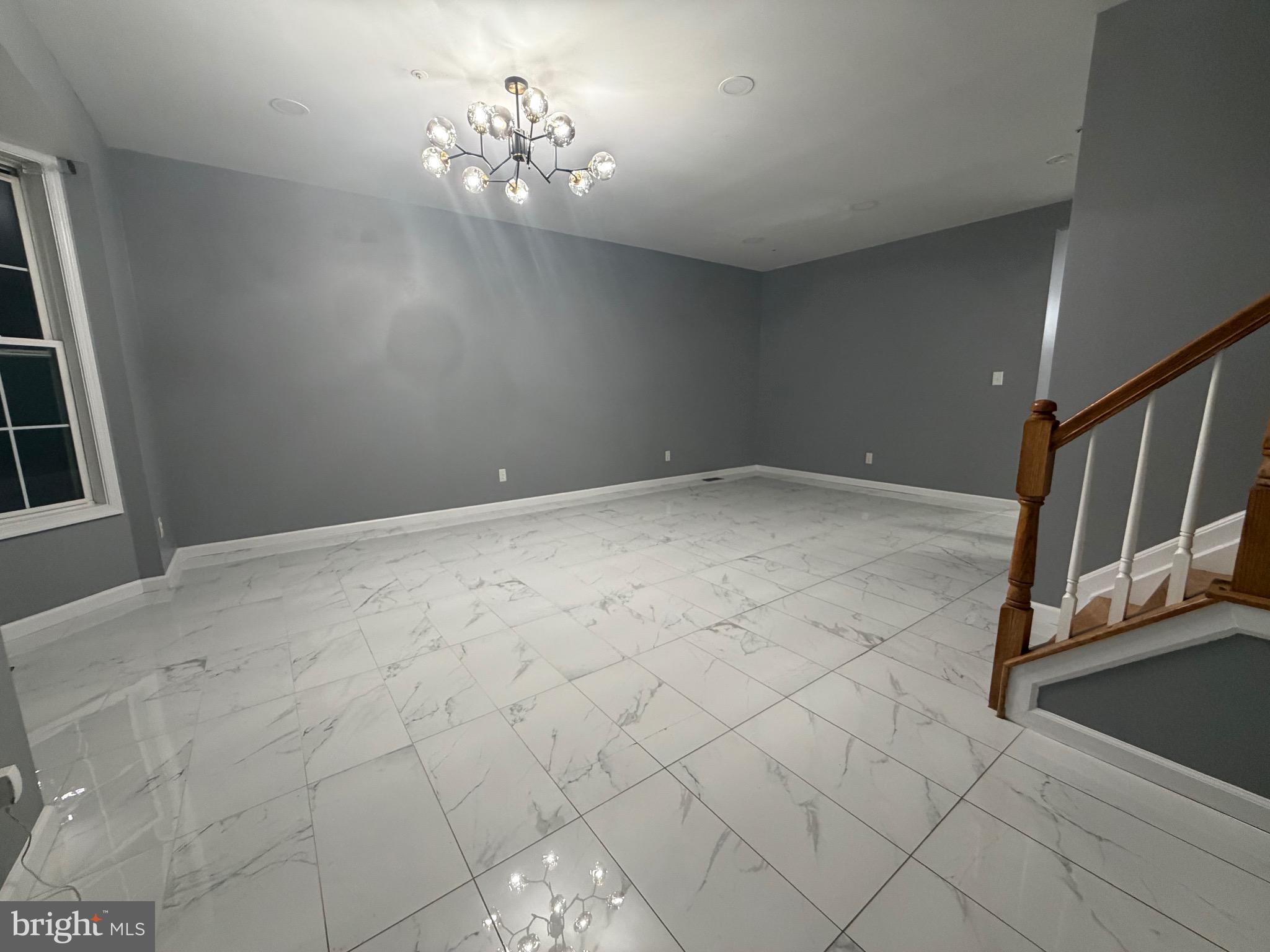 7704 Periwinkle Way Severn, MD 21144 - Photo 17 of 18 a view of an empty room with a chandelier fan