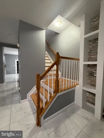 a view of a hallway with seating and white walls