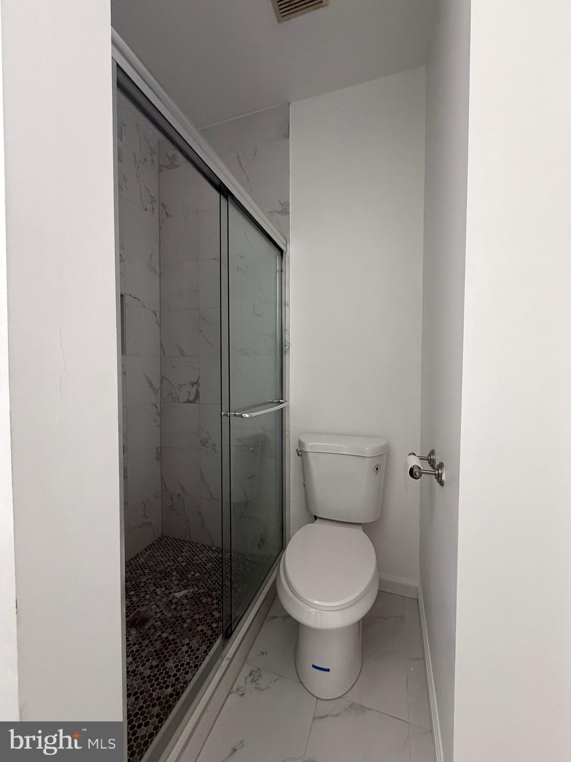 7704 Periwinkle Way Severn, MD 21144 - Photo 4 of 18 a white toilet sitting next to a shower