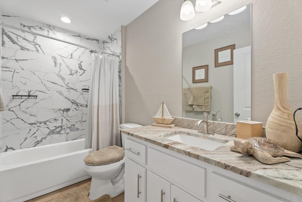 8288 Southwest Sunnybreeze Road Arcadia, FL 34269 - Photo 13 of 18 a bathroom with a granite countertop sink toilet and shower