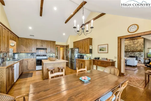 a large kitchen with a table and chairs