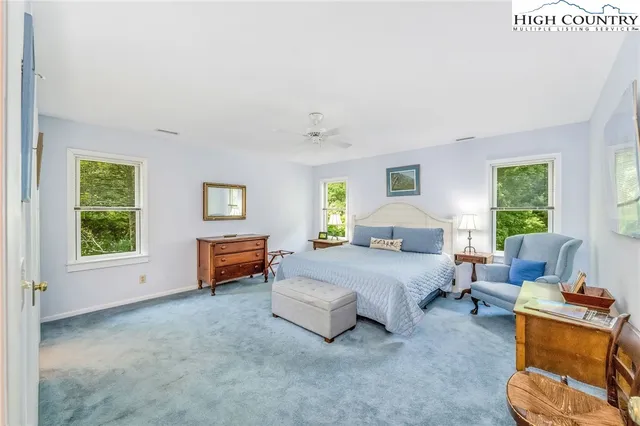 a spacious bedroom with a bed and a couch