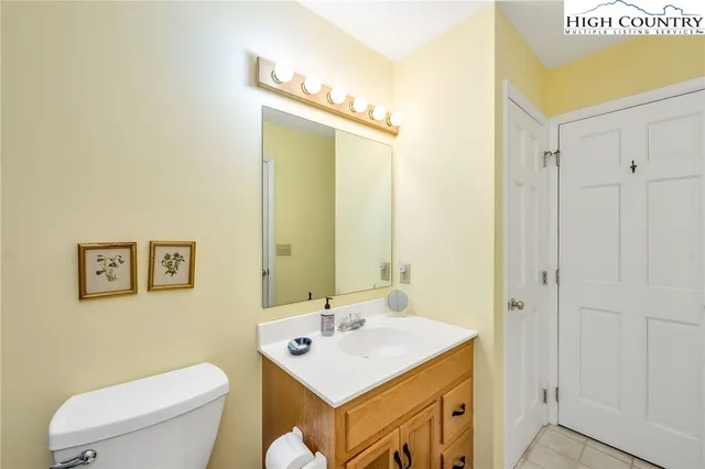 a bathroom with a sink mirror vanity and toilet