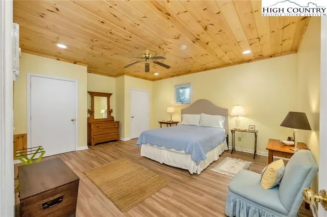 a spacious bedroom with a bed and furniture