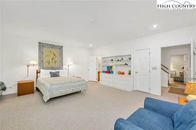 a bedroom with furniture and white walls