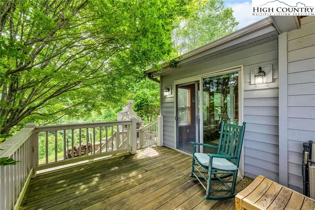 a view of balcony with wooden floor and outdoor seating