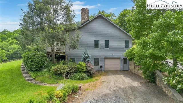 a view of a house with a yard and plants