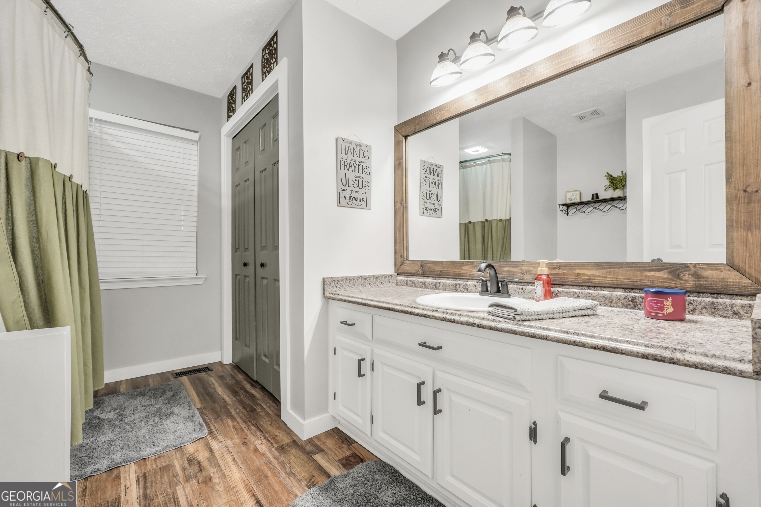 533 Chuli Road Griffin, GA 30223 - Photo 13 of 53 a bathroom with a granite countertop sink and a mirror