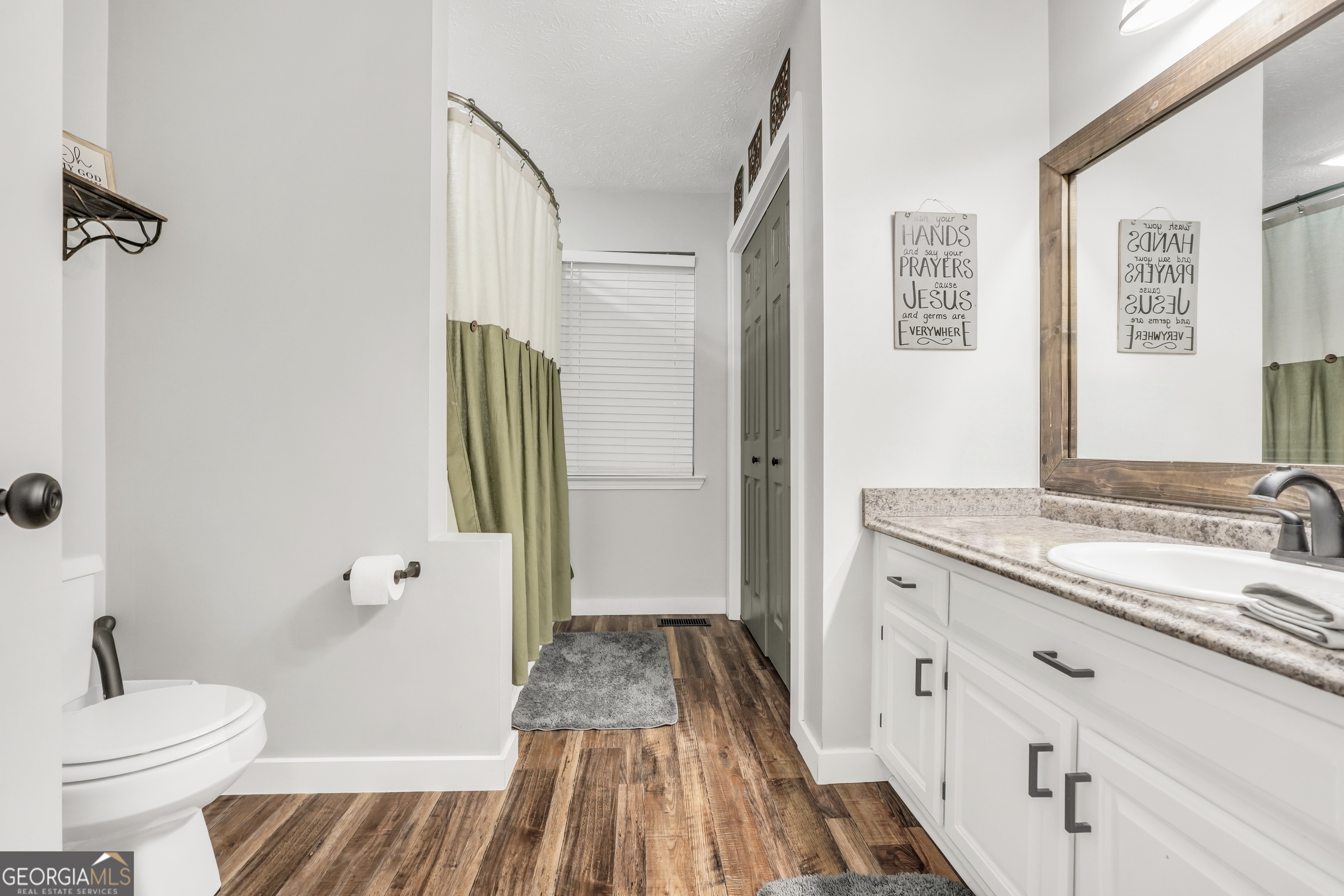 533 Chuli Road Griffin, GA 30223 - Photo 15 of 53 a bathroom with a granite countertop sink toilet and shower