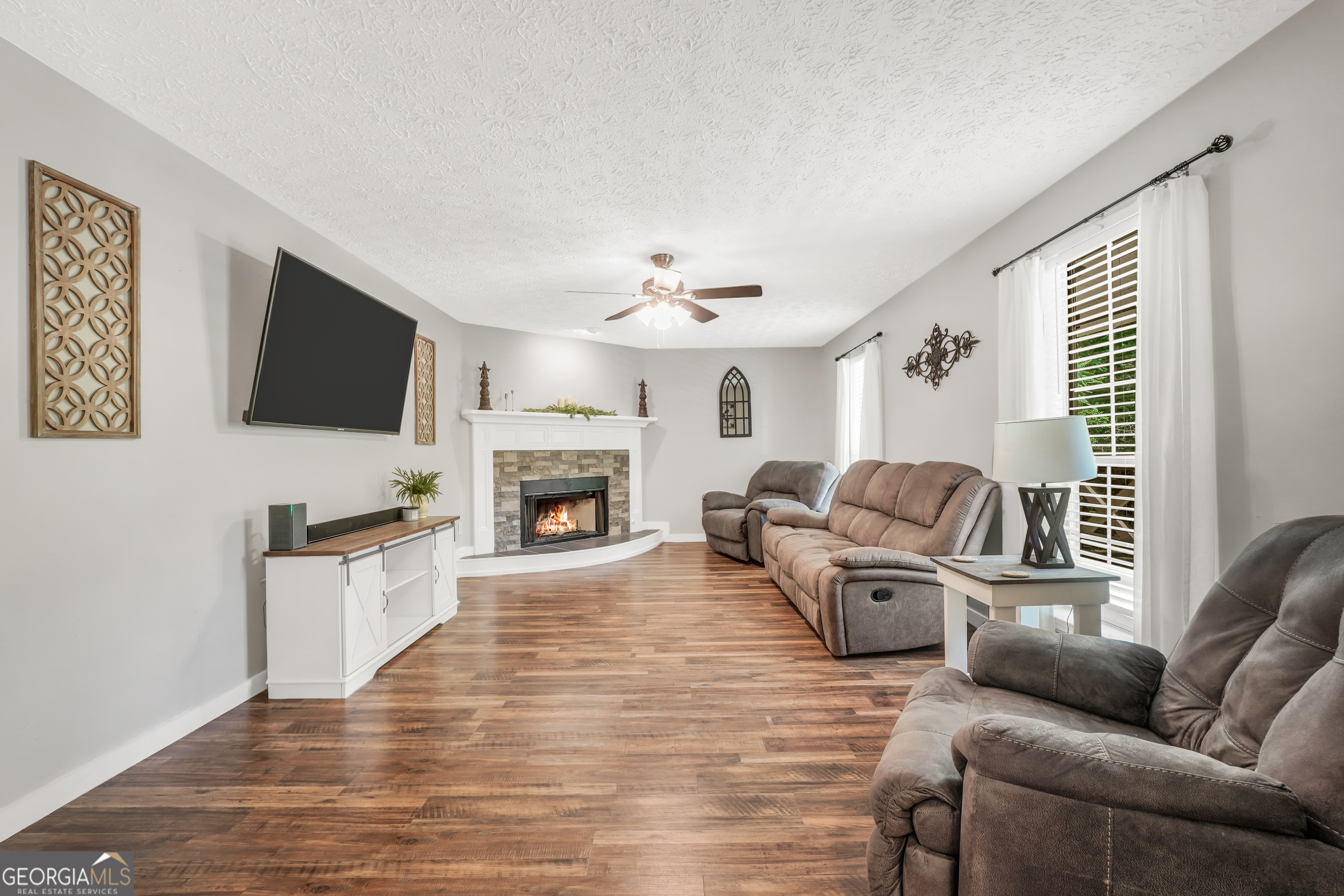 533 Chuli Road Griffin, GA 30223 - Photo 20 of 53 a living room with furniture a flat screen tv and a fireplace