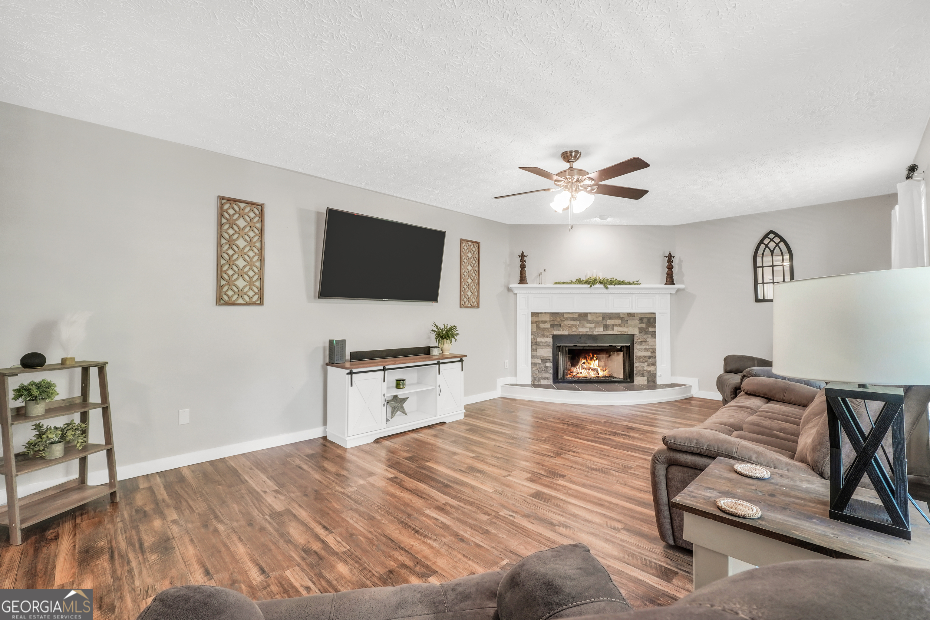 533 Chuli Road Griffin, GA 30223 - Photo 21 of 53 a living room with furniture and a fireplace