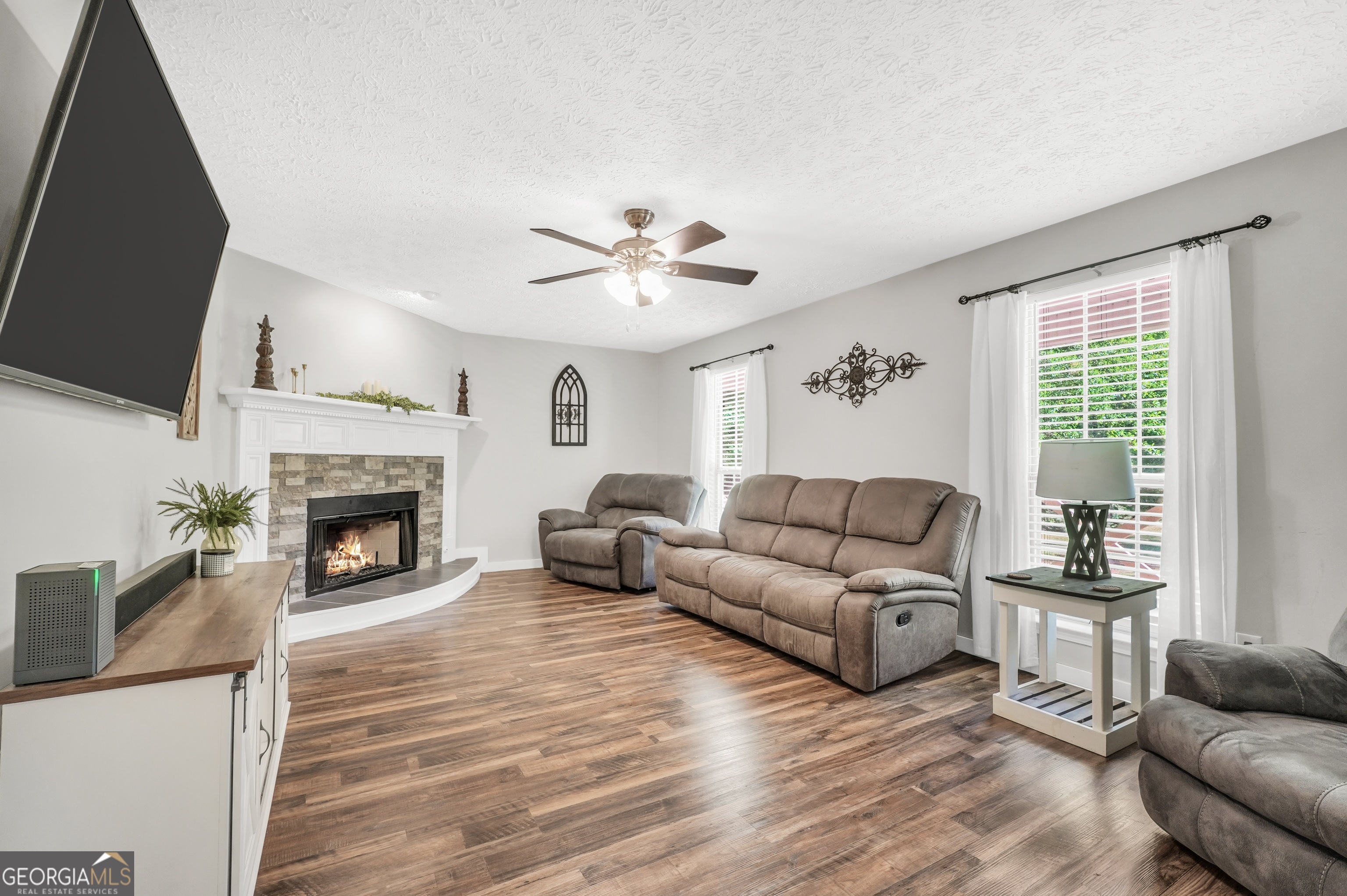 533 Chuli Road Griffin, GA 30223 - Photo 22 of 53 a living room with furniture and a fireplace