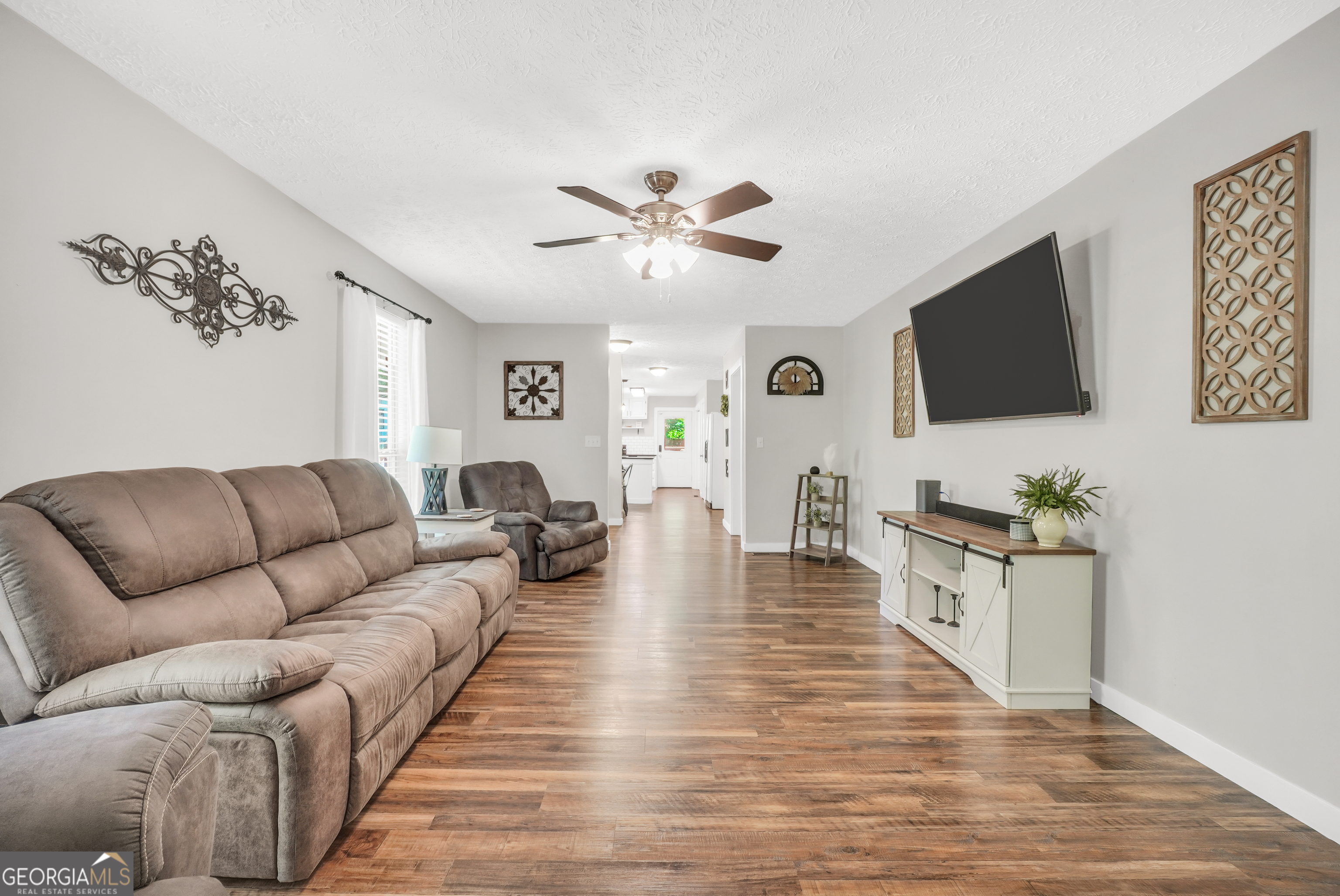 533 Chuli Road Griffin, GA 30223 - Photo 23 of 53 a living room with furniture and a flat screen tv