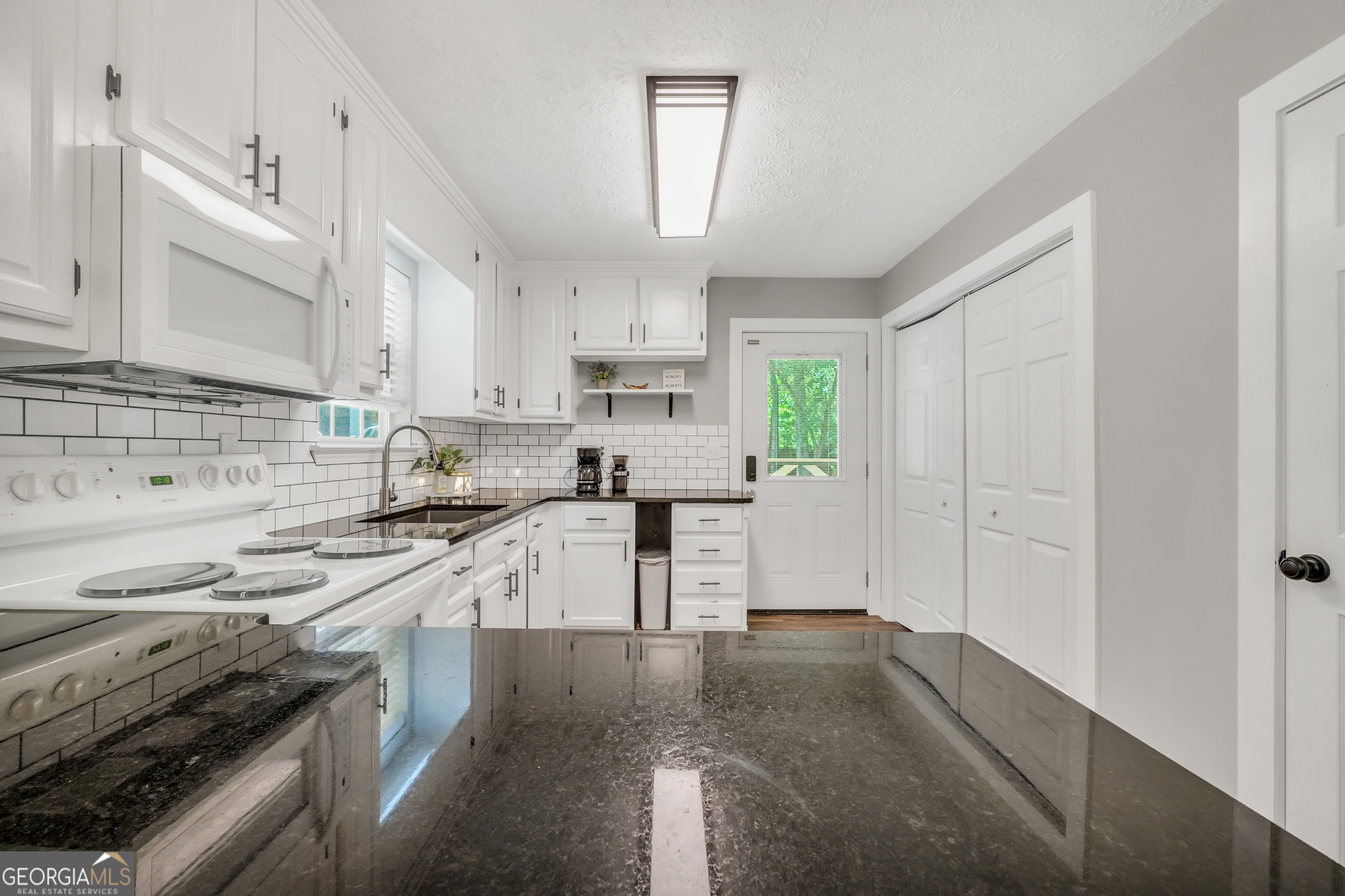 533 Chuli Road Griffin, GA 30223 - Photo 29 of 53 a kitchen with granite countertop a sink stainless steel appliances and cabinets