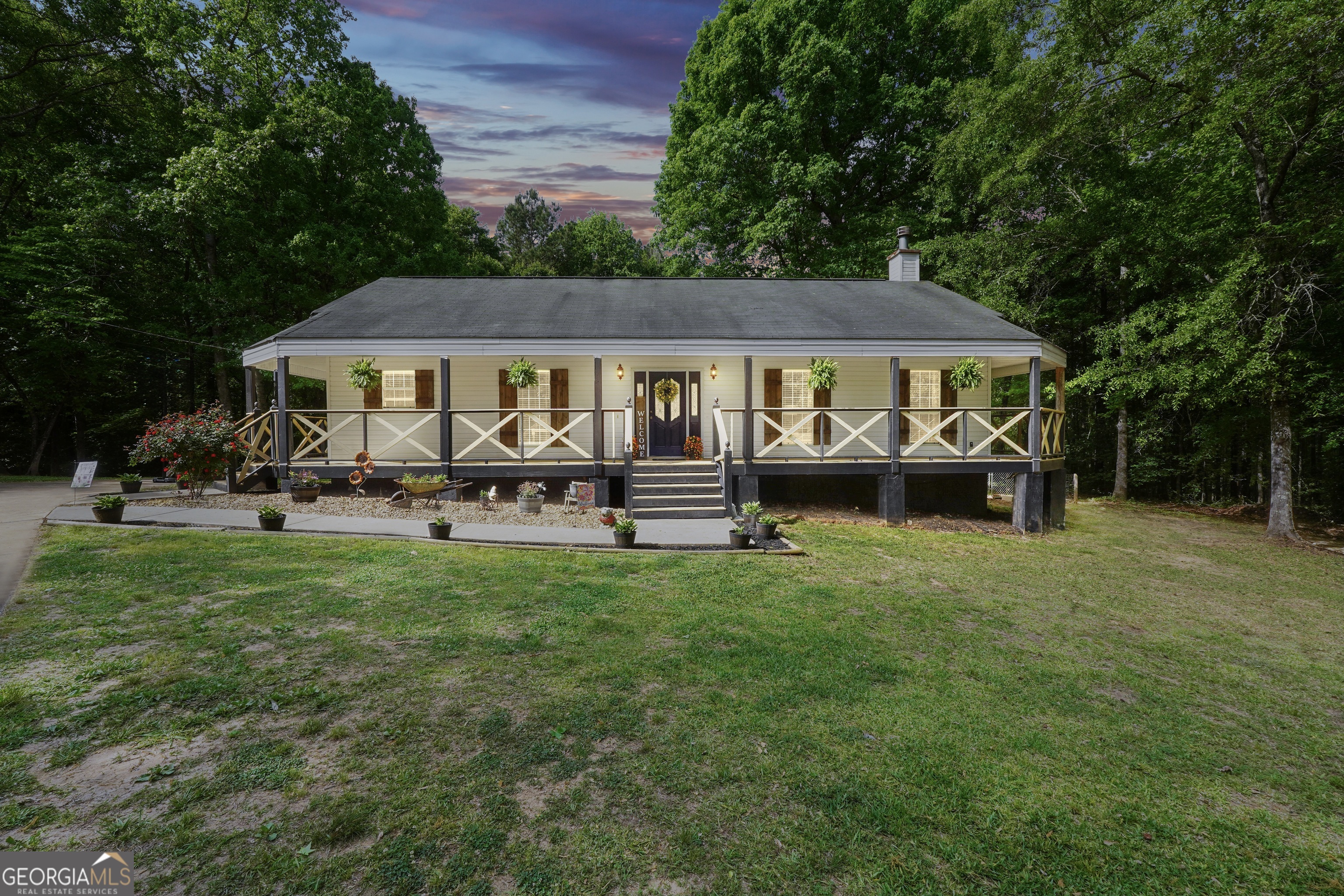 533 Chuli Road Griffin, GA 30223 - Photo 6 of 53 a front view of a house with a garden and trees
