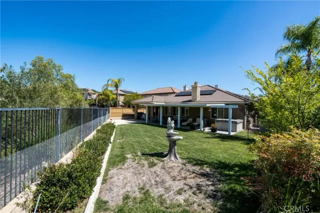 a view of house with backyard outdoor seating and green space