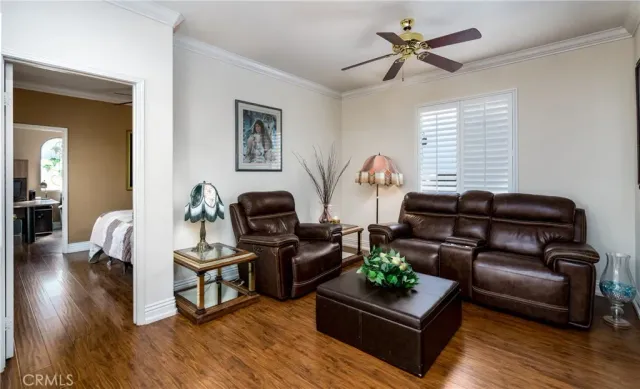 a bedroom with a bed a dresser and wooden floor
