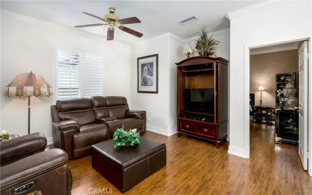 a view of a workspace with furniture and wooden floor