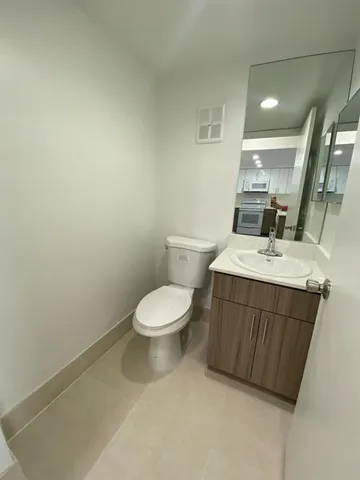a bathroom with a sink a toilet and mirror
