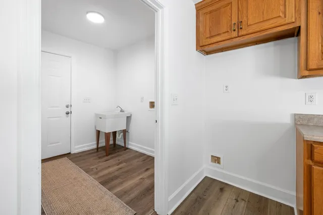 a view of a room with wooden floor cabinets