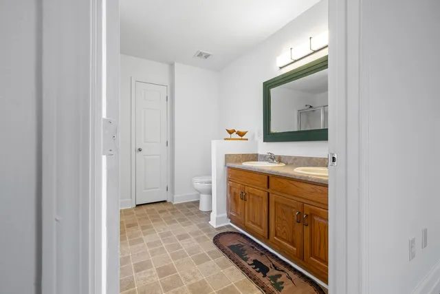 a bathroom with a sink mirror and vanity