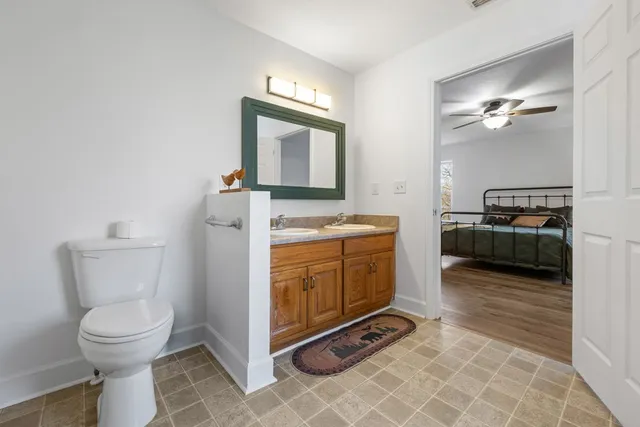 a view of bathroom with toilet sink and mirror
