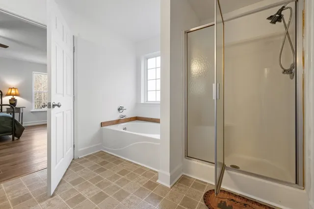 a bathroom with a tub and a shower