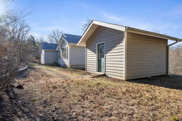 a view of a yard with trees in the background