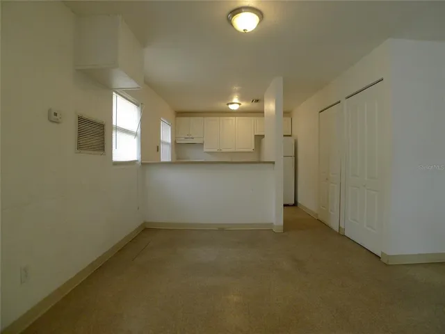 a view of a kitchen with a sink and cabinets