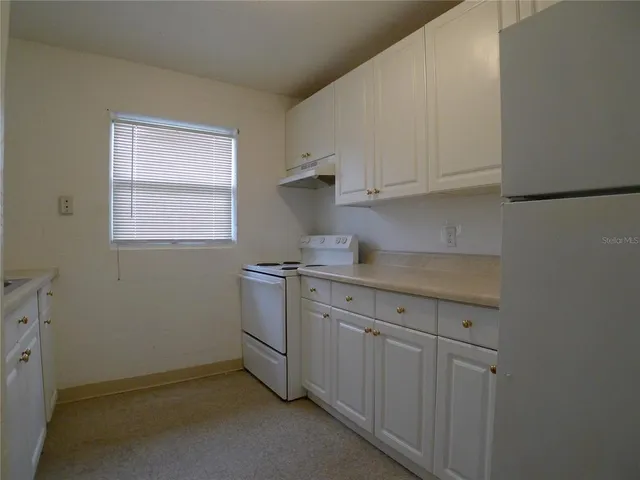 a room with a sink cabinets and utility room