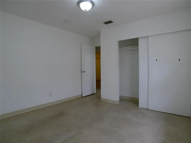 an empty room with closet area