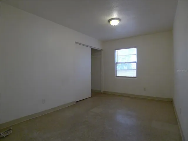 an empty room with a empty space and windows