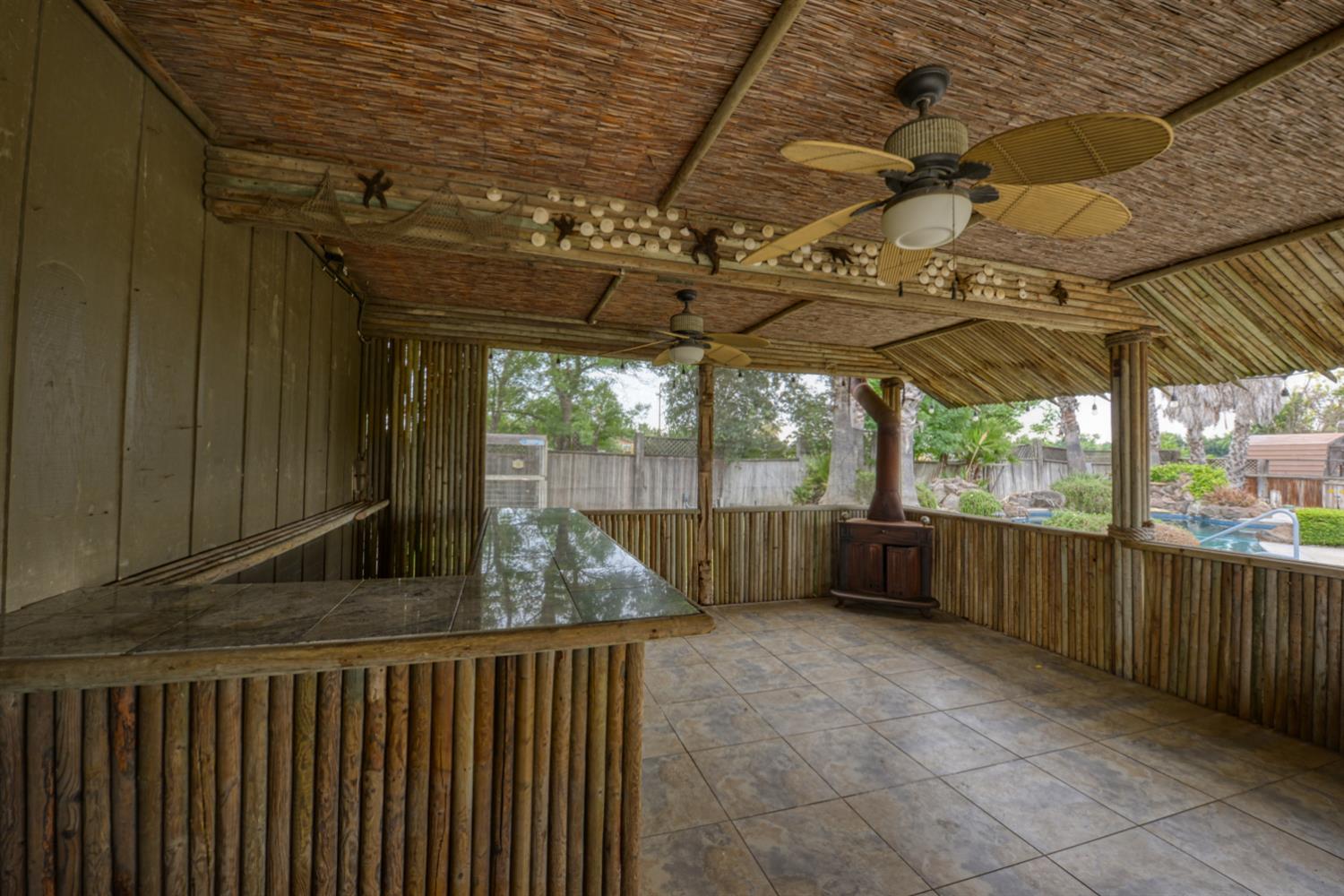 2931 East Marshall Road Patterson, CA 95363 - Photo 28 of 54 Tiki Bar with ceiling fan and tile floor