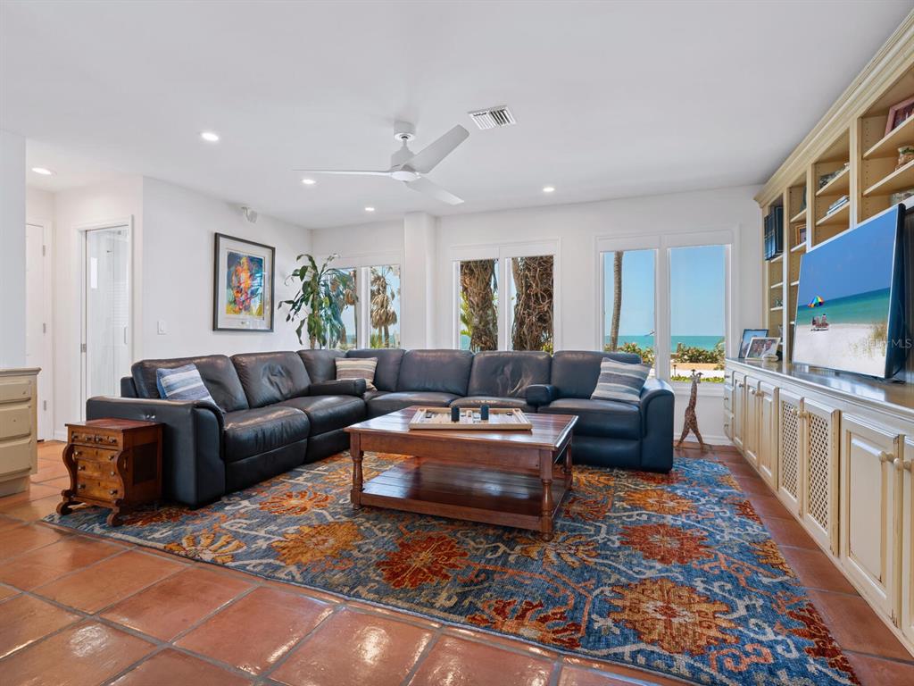 3300 Casey Key Road Nokomis, FL 34275 - Photo 14 of 65 a living room with furniture a rug and a flat screen tv
