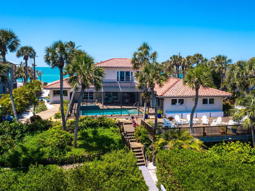 3300 Casey Key Road Nokomis, FL 34275 - Photo 2 of 65 a front view of a house with a garden