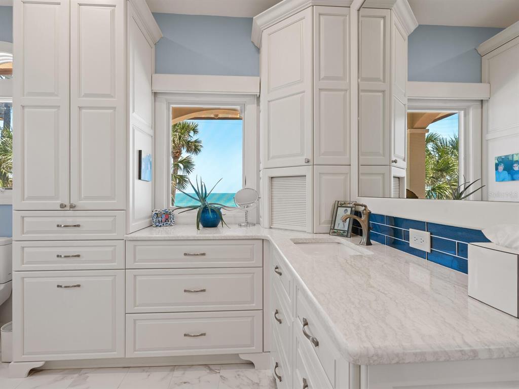 3300 Casey Key Road Nokomis, FL 34275 - Photo 24 of 65 a bathroom with a sink and a large mirror