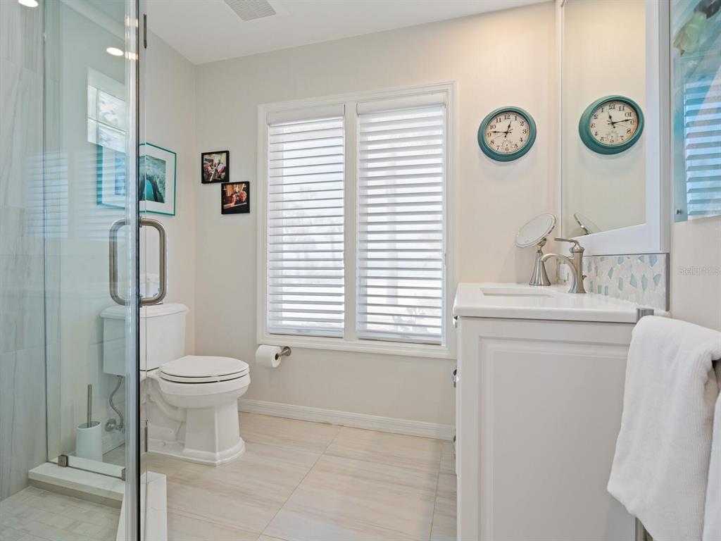 3300 Casey Key Road Nokomis, FL 34275 - Photo 30 of 65 a bathroom with a toilet sink and mirror
