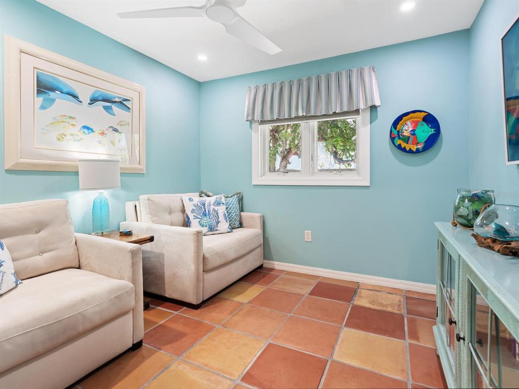 3300 Casey Key Road Nokomis, FL 34275 - Photo 32 of 65 a living room with furniture and a white wall next to a window