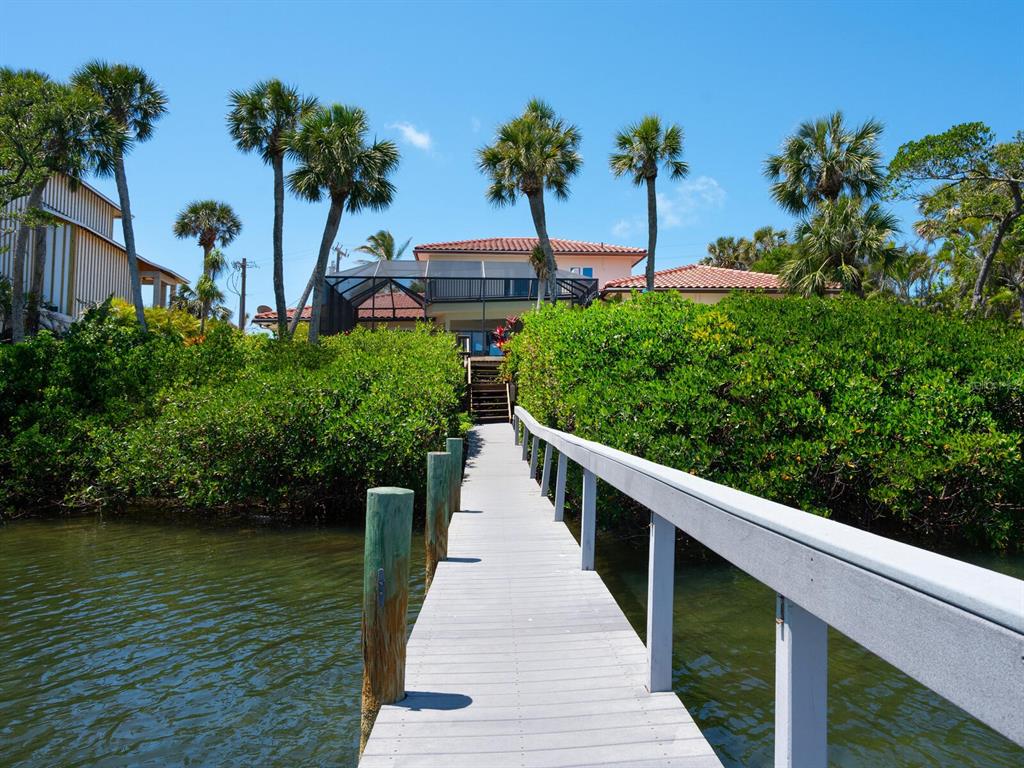 3300 Casey Key Road Nokomis, FL 34275 - Photo 41 of 65 a view of a house with a yard and potted plants