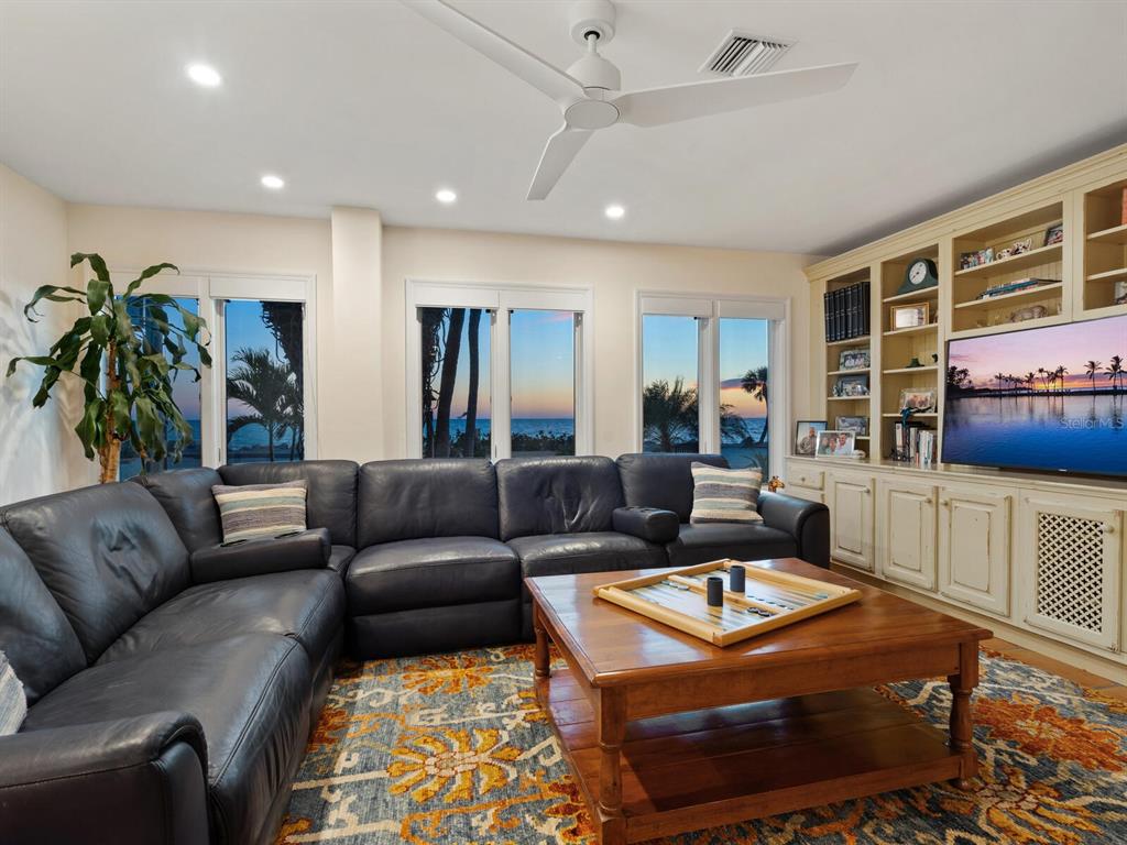 3300 Casey Key Road Nokomis, FL 34275 - Photo 50 of 65 a living room with furniture and a flat screen tv