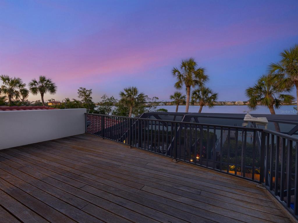 3300 Casey Key Road Nokomis, FL 34275 - Photo 55 of 65 a view of a balcony with wooden floor and a potted plants