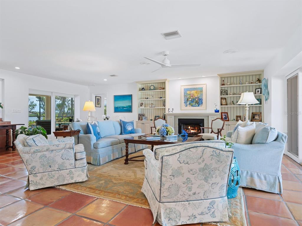 3300 Casey Key Road Nokomis, FL 34275 - Photo 7 of 65 a living room with fireplace furniture and a large window