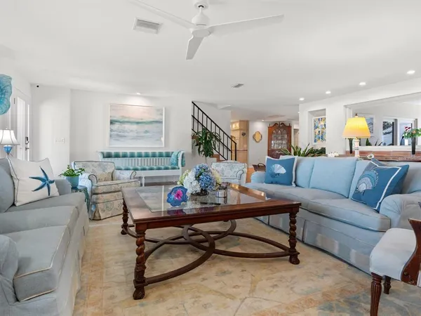 a large dining hall with stainless steel appliances lots of counter top space and furniture