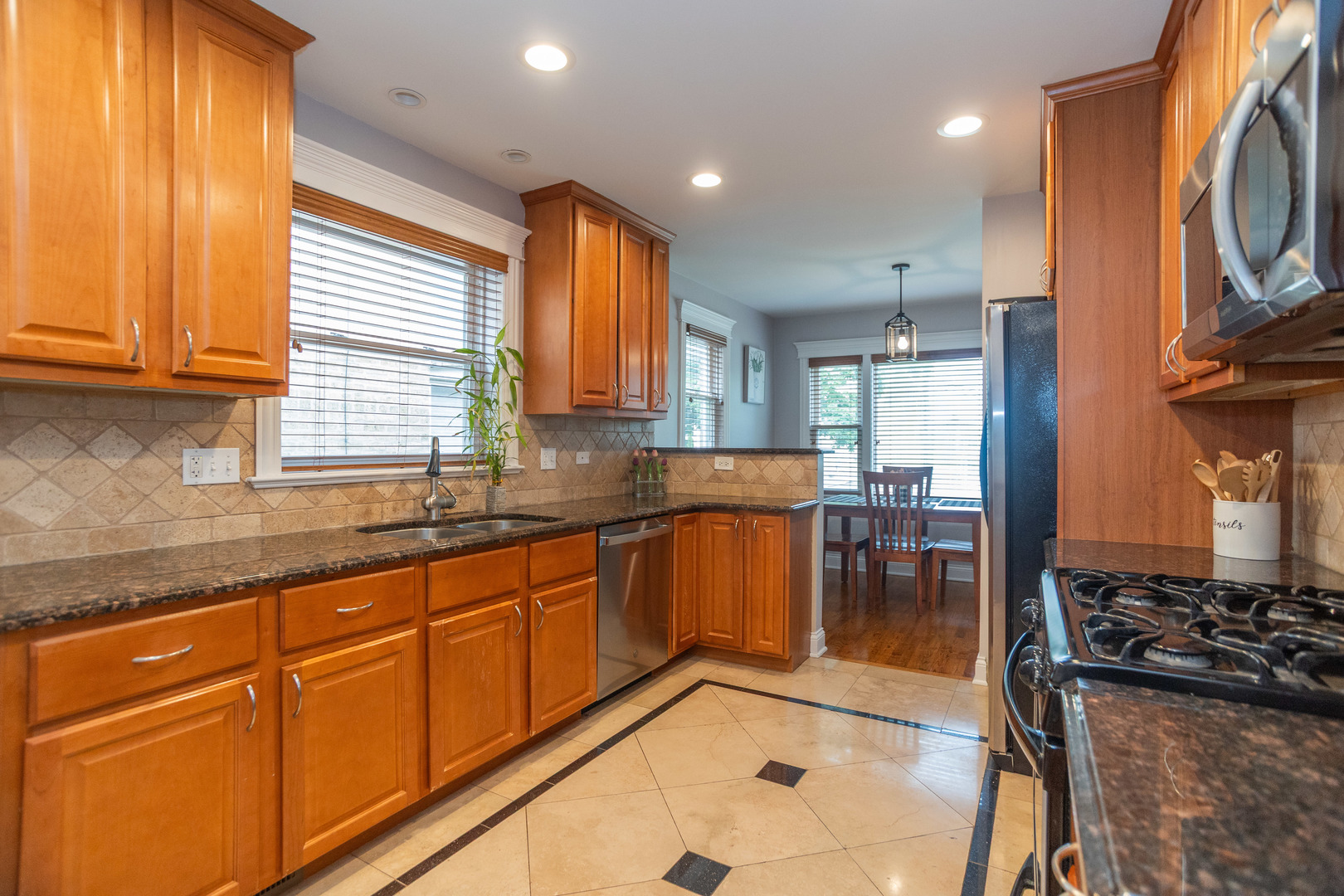5328 North Rutherford Avenue Chicago, IL 60656 - Photo 14 of 40 a kitchen with stainless steel appliances granite countertop a stove a sink and a microwave