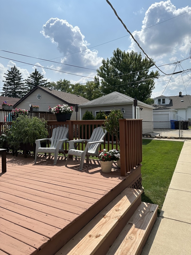 5328 North Rutherford Avenue Chicago, IL 60656 - Photo 32 of 40 a view of a patio with table and chairs under an umbrella with a barbeque