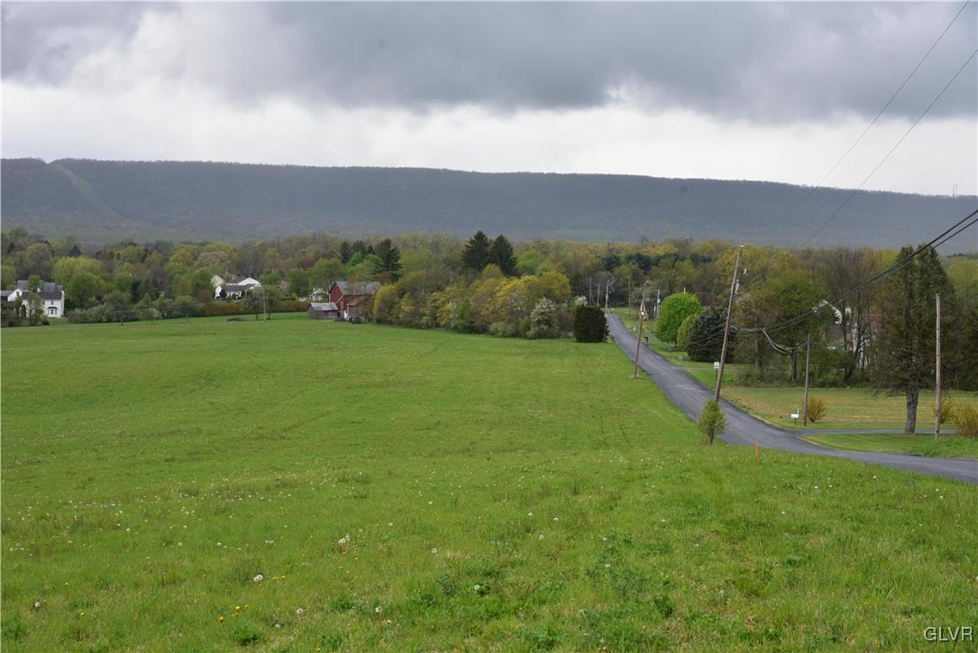 1269 Keller Road, Unit LOT #2 Wind Gap, PA 18091 - Photo 2 of 6 a view of a green field with mountains in the background