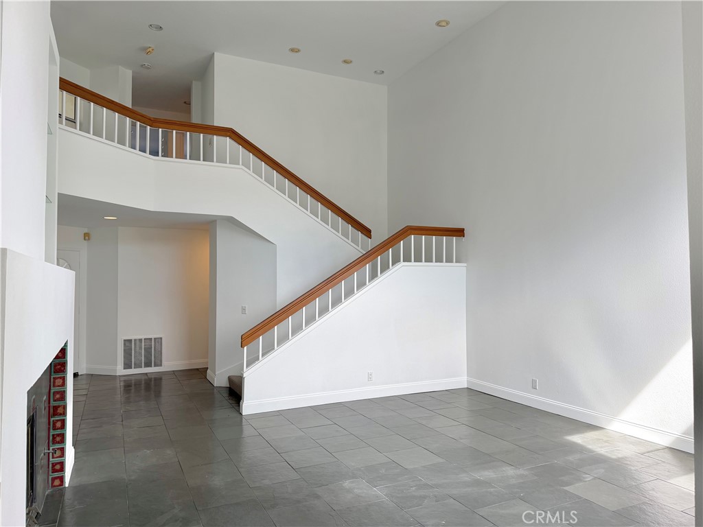 4 Del Rey, Unit 19 Irvine, CA 92612 - Photo 17 of 25 SPACIOUS LIVING ROOM AREA WITH VAULTED CEILINGS AND A COZY FIRE PLACE!