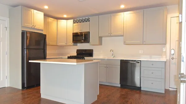 a kitchen with stainless steel appliances a refrigerator sink and cabinets