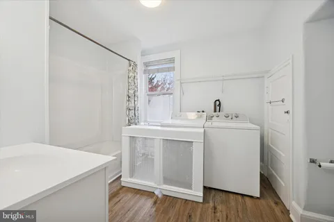 a utility room with cabinets washer and dryer